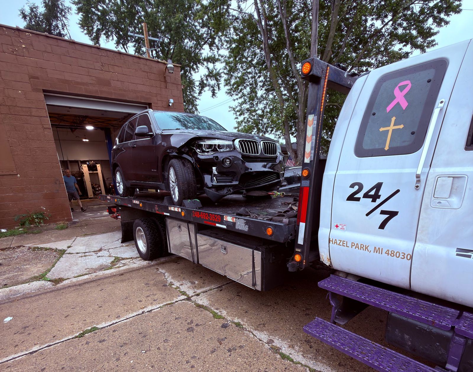 James Towing flatbed carrying a wrecked SUV after an accident
