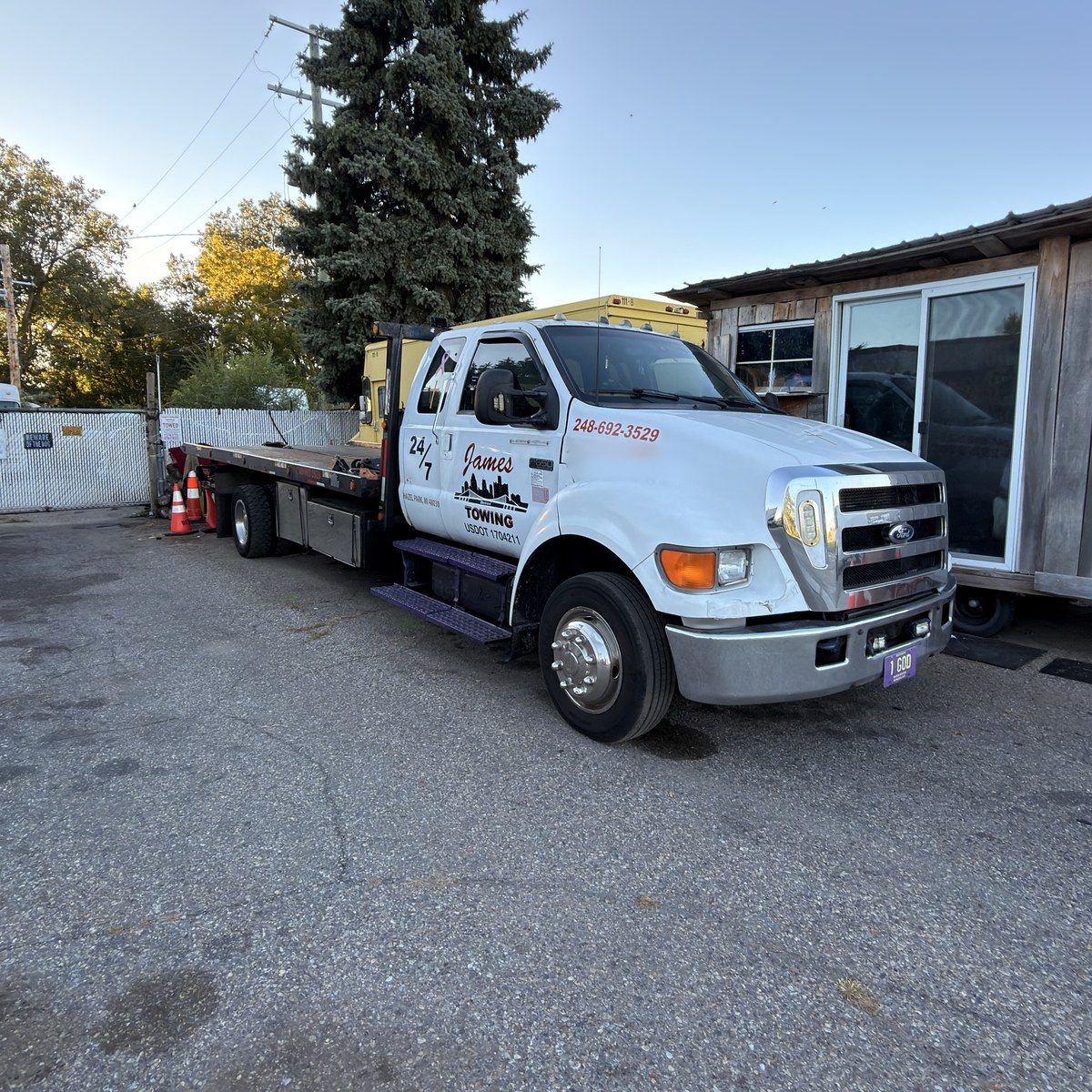 Front view of the James Towing white F-650 flatbed tow truck