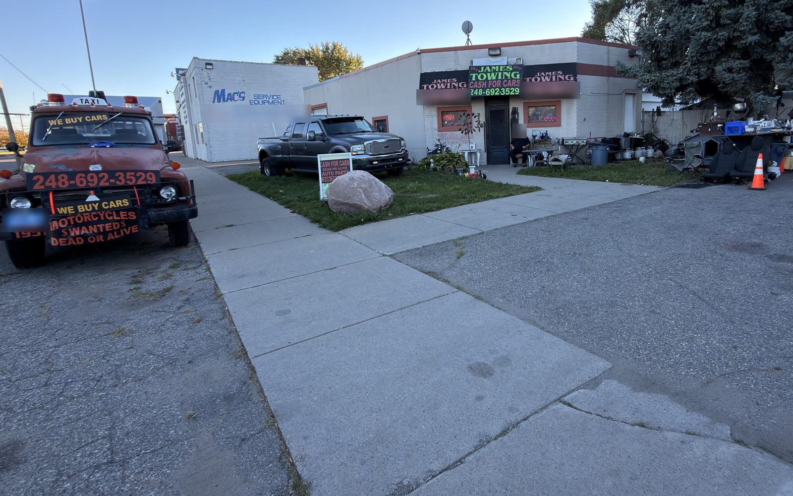 James Towing shop at 21201 Dequindre Rd, Hazel Park, with a red tow truck out front